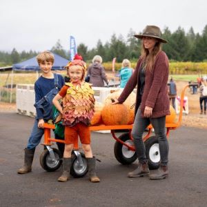 family at fall festival with pumpkins